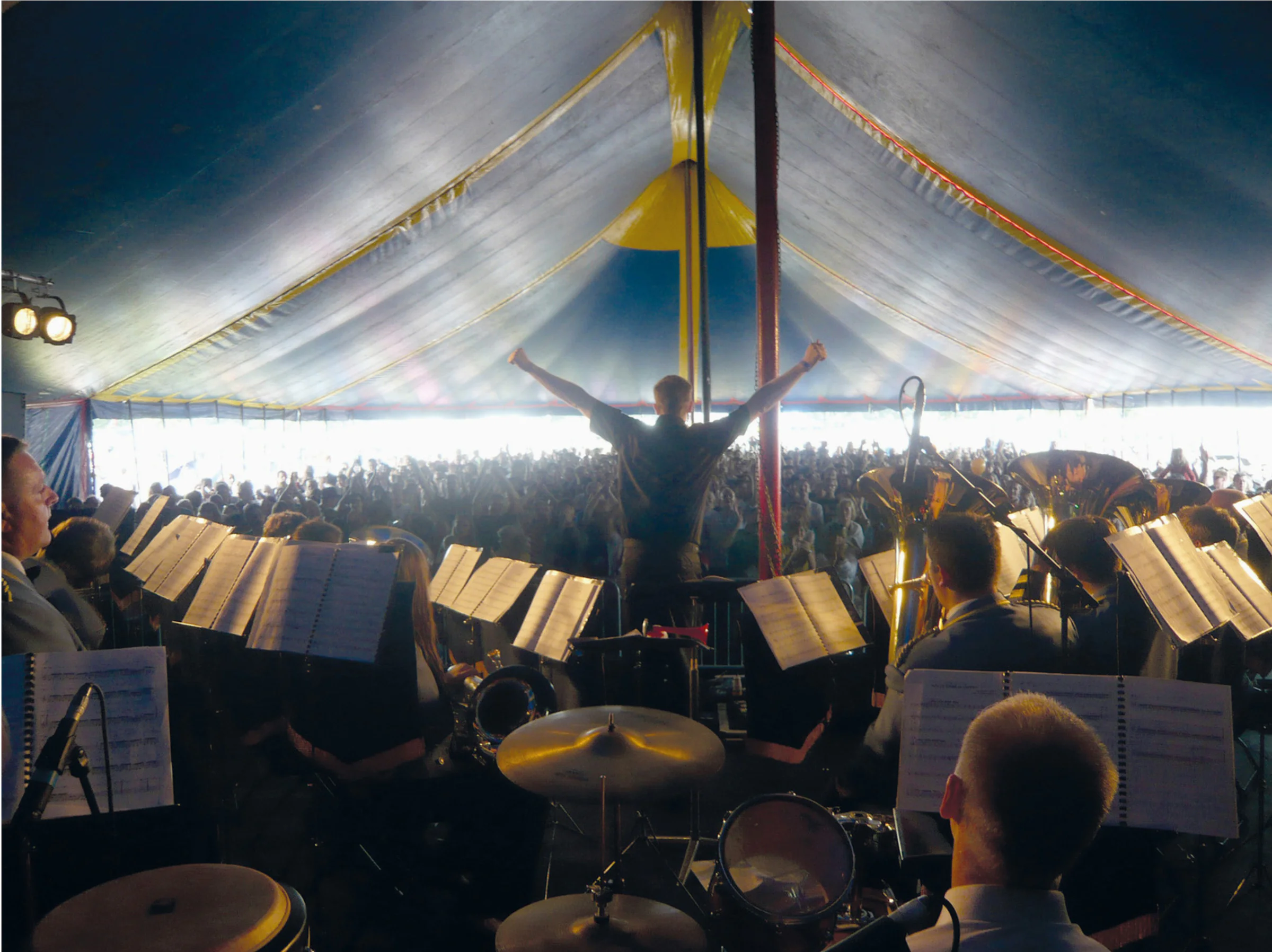 Acid Brass performing to a packed audience beneath a festival big top