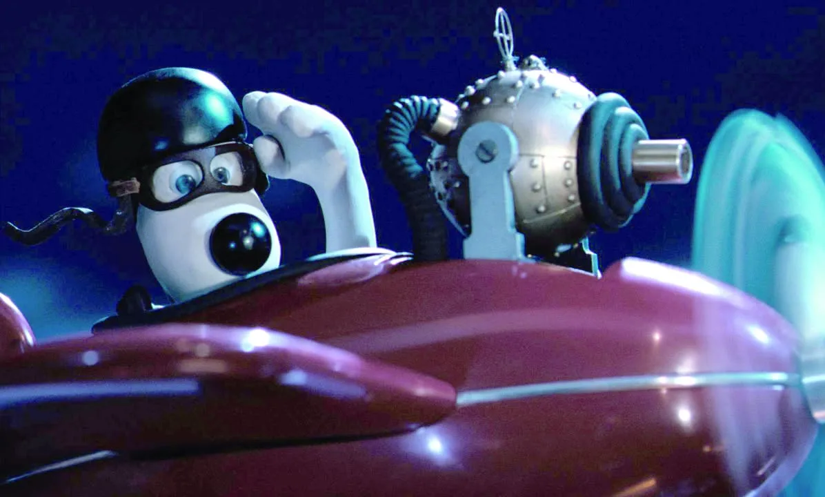 Gromit wearing flying goggles at the controls of the sidecar plane in A Close Shave