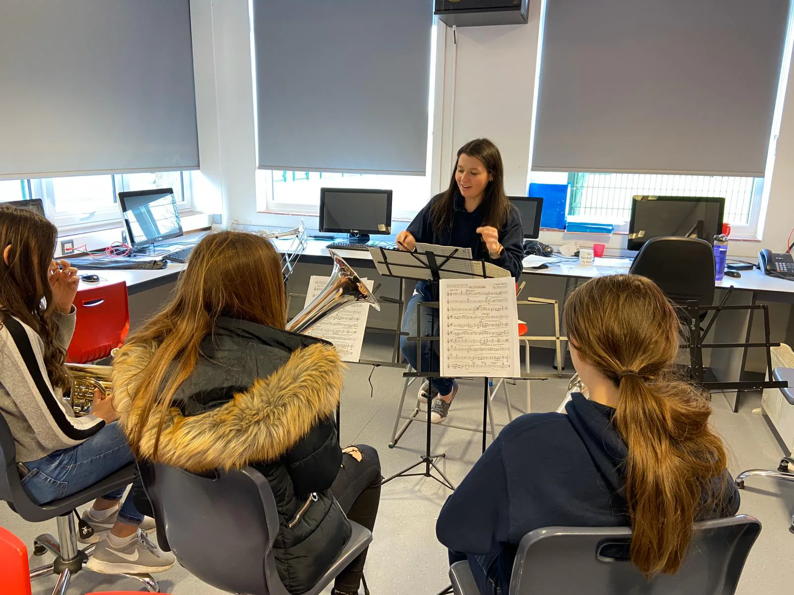 A Fairey tutor working with young brass musicians